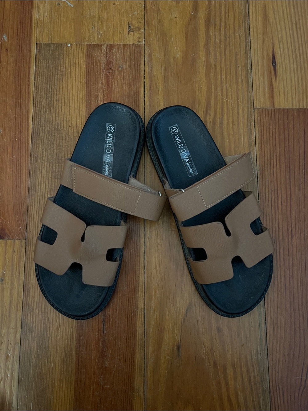 Tan ladies Wild Diva lounge slip on with H design across top, adjustable Velcro.